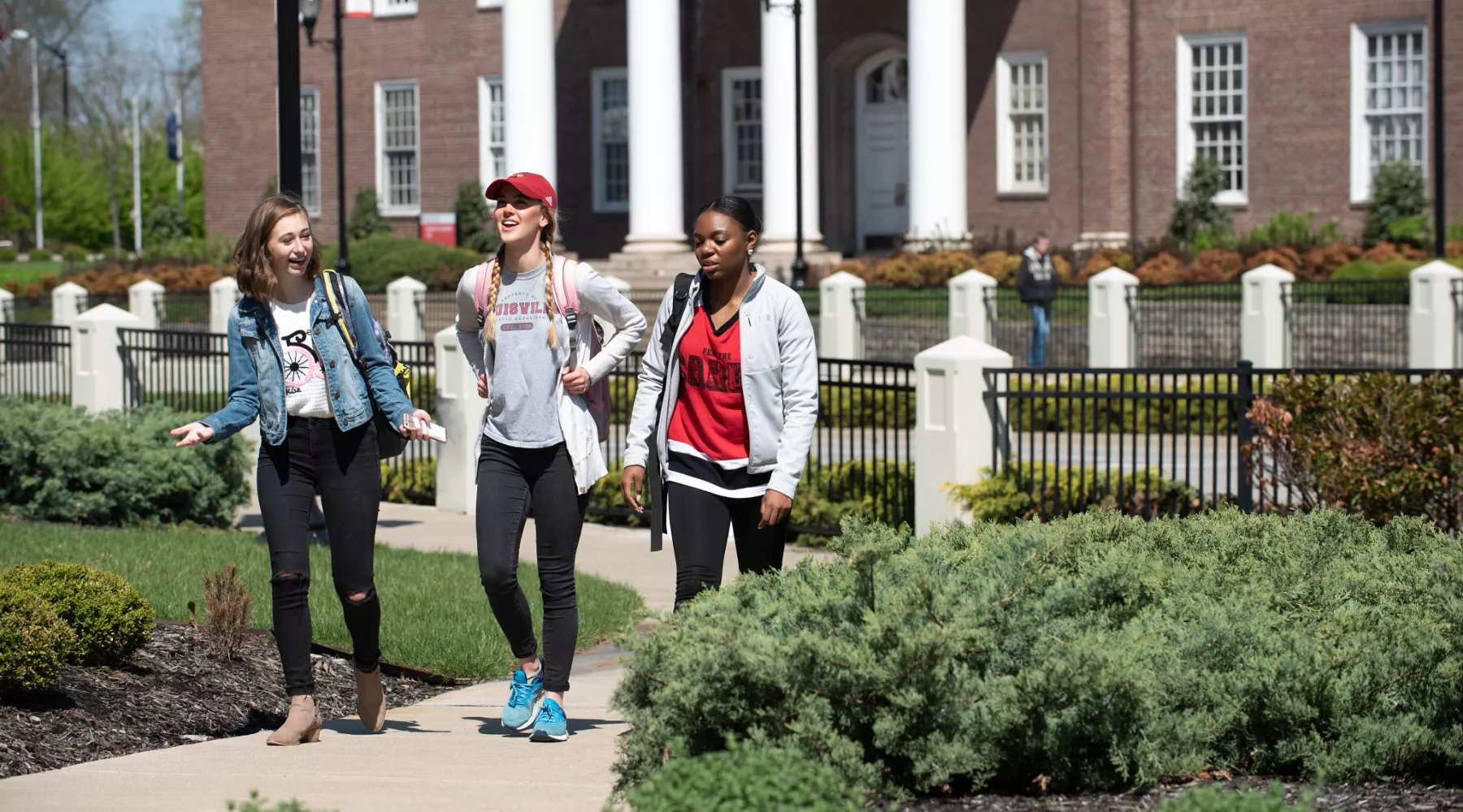Three students walk through campus