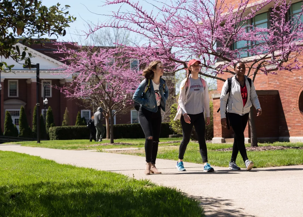 Students walking on campus on a spring day