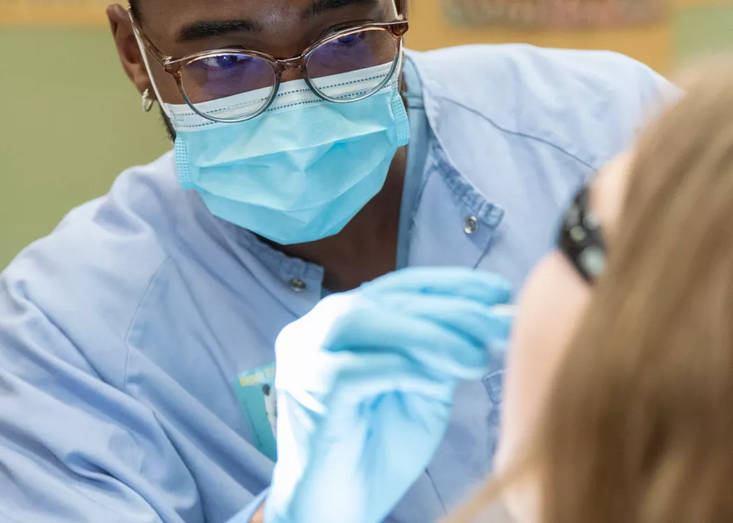 Dental student examining a patient