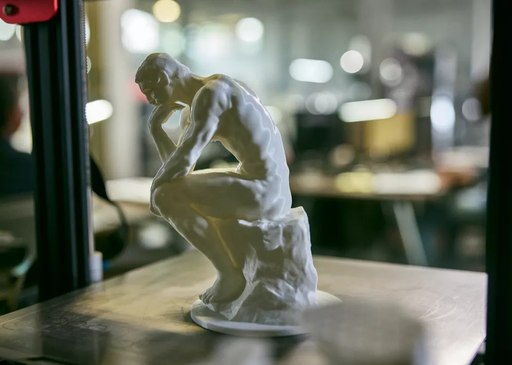 A miniature sculpture of the Thinker in the AMIST facility.