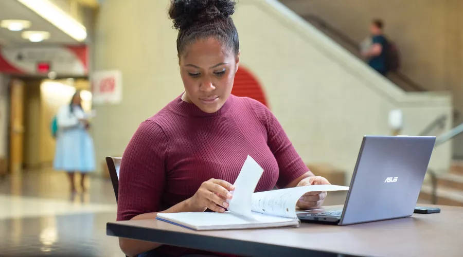 Female student studying academic materials in the college of business.
