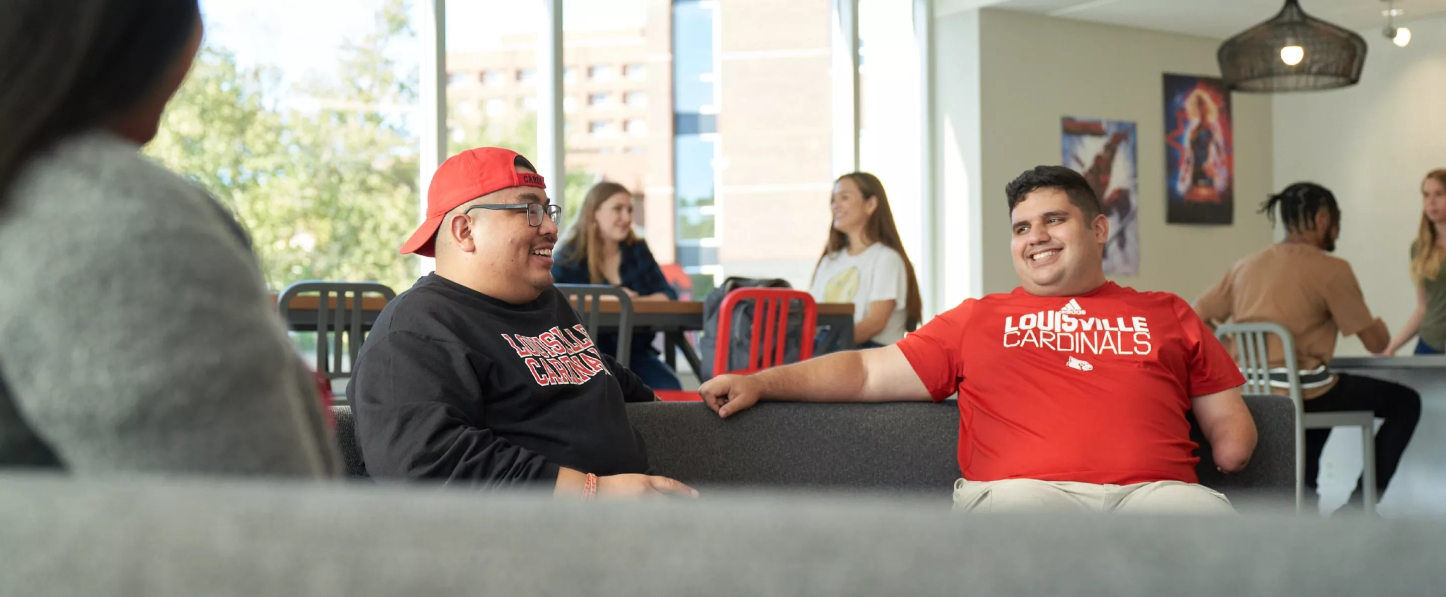 Students sitting on the couches and talking in the Belknap Residence Hall.
