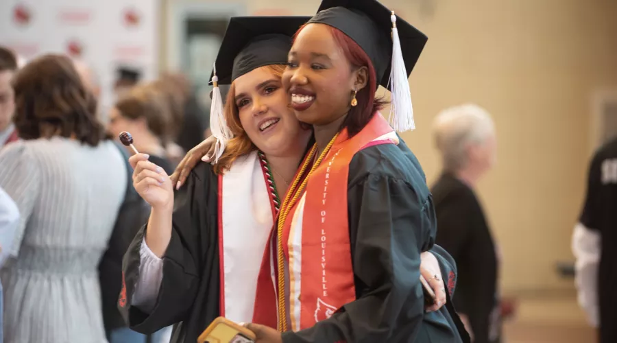 Students hug in celebration at Commencement 2022