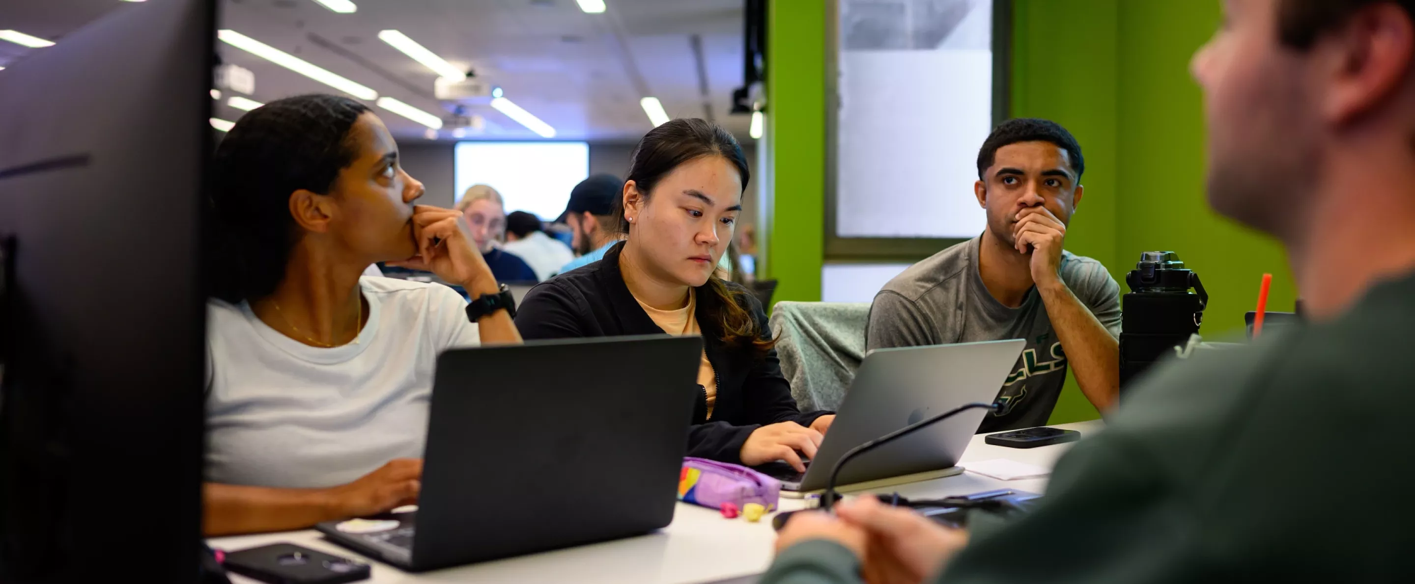 Students in a lecture in the School of Medicine, working in tables and interacting
